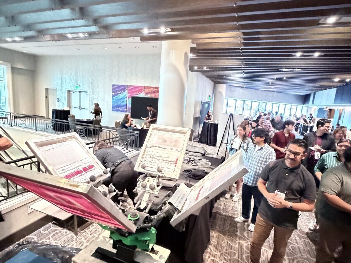Crowd lined up at a live printing station