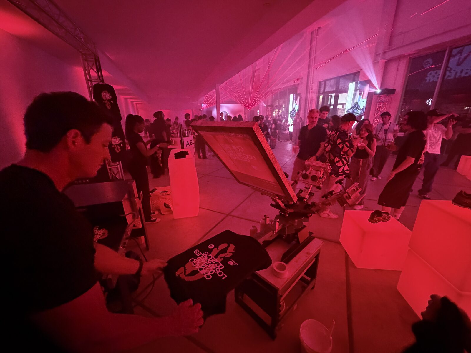 Guest holding a freshly printed custom shirt at an event